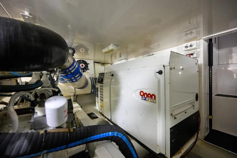 Slide: The Image of Engine room of 2004 Viking 48 Convertible yacht with Onan generator and piping. - 17