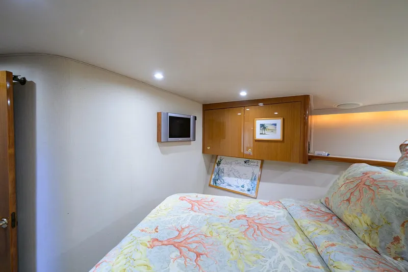 Slide: The Image of Luxurious cabin interior of 2004 Viking 48 Convertible yacht with elegant bedding and wall art. - 40