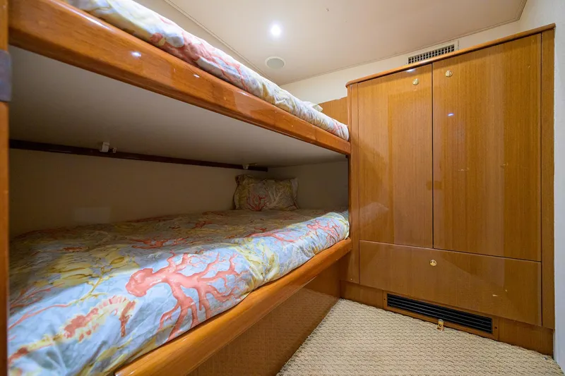 Slide: The Image of Bunk beds in 2004 Viking 48 Convertible yacht cabin with wooden cabinetry. - 47