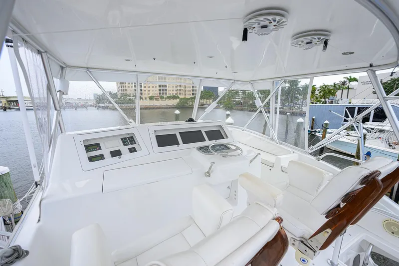 Slide: The Image of Helm of 2004 Viking 48 Convertible yacht with modern controls and waterfront view. - 54