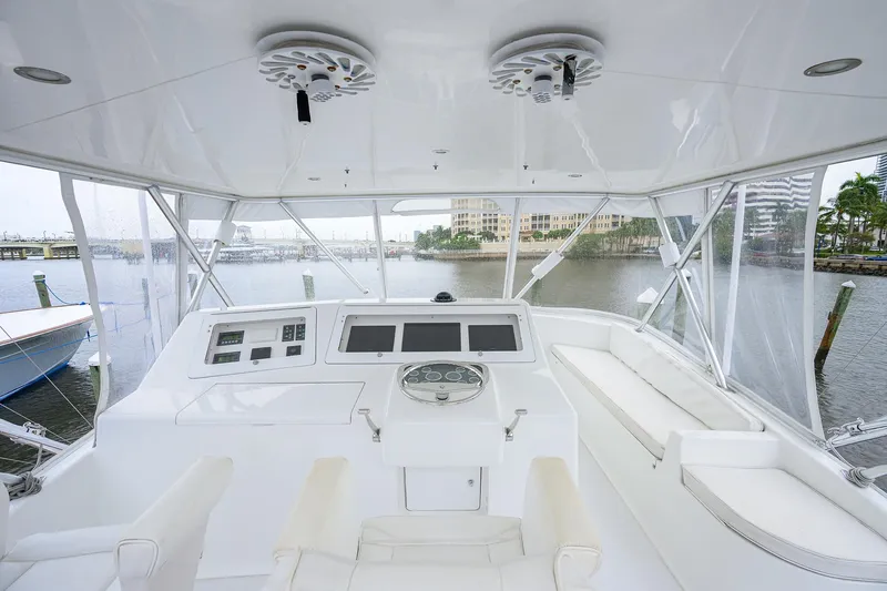 Slide: The Image of 2004 Viking 48 Convertible yacht helm with modern controls and panoramic marina view. - 55