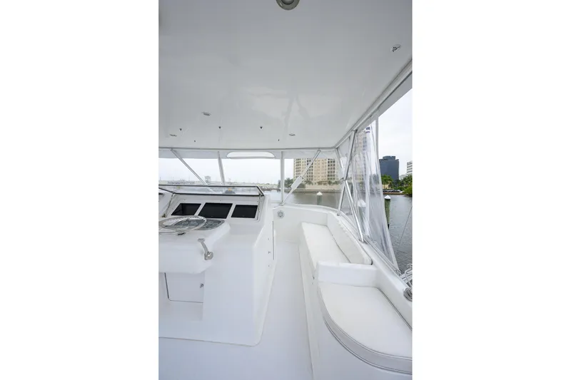 Slide: The Image of 2004 Viking 48 Convertible yacht interior with helm and seating area. - 63