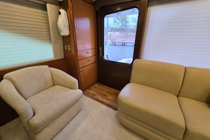 Slide: The Image of Interior of 2004 Ocean Yachts 50 Super Sport with beige seating and wood accents. - 12