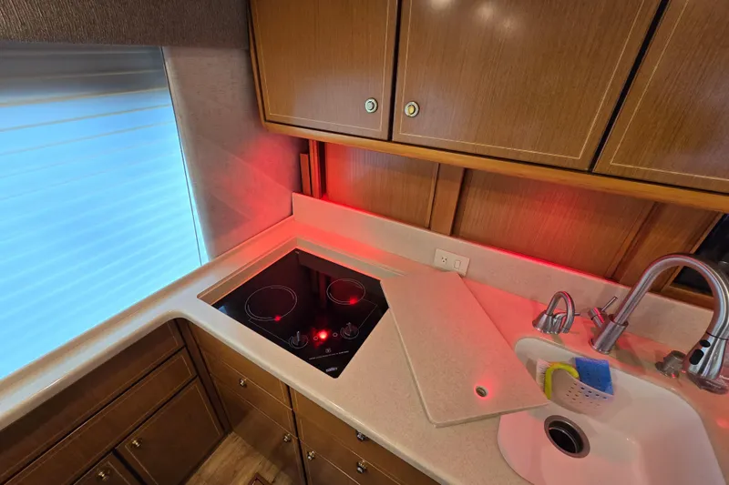 Slide: The Image of Kitchen area of a 2004 Ocean Yachts 50 Super Sport with stove and sink. - 14