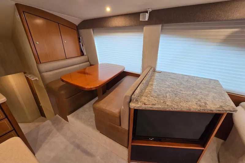 Slide: The Image of Interior of 2004 Ocean Yachts 50 Super Sport with dining area and marble countertop. - 18