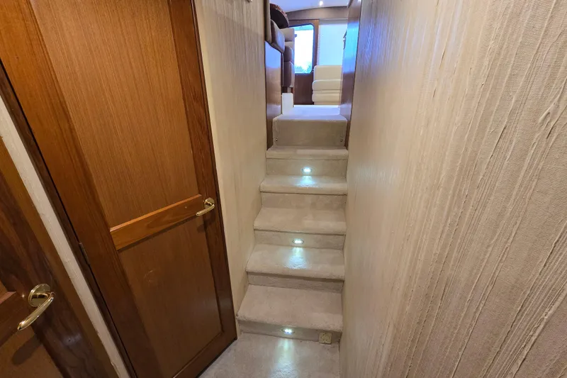 Slide: The Image of Interior hallway of 2004 Ocean Yachts 50 Super Sport with carpeted stairs and wooden doors. - 20