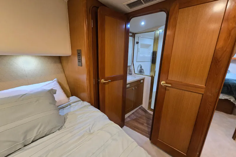 Slide: The Image of Luxurious cabin interior of 2004 Ocean Yachts 50 Super Sport with wooden doors and cozy bedding. - 24