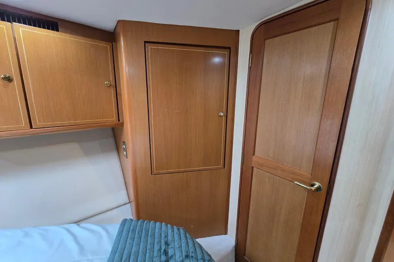 Slide: The Image of Interior cabin of 2004 Ocean Yachts 50 Super Sport with wooden cabinetry and door. - 28