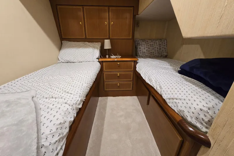Slide: The Image of Twin beds in a cozy cabin of a 2004 Ocean Yachts 50 Super Sport. - 29