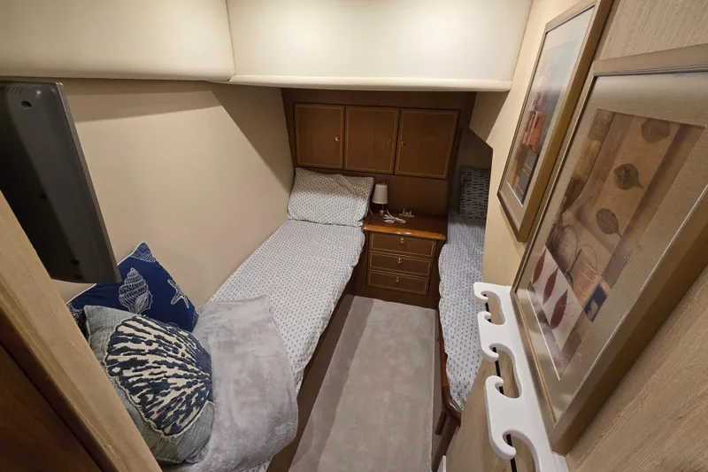 Slide: The Image of Cozy cabin interior of 2004 Ocean Yachts 50 Super Sport with twin beds and nautical decor. - 30