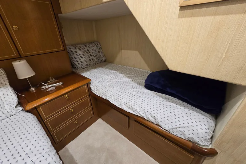 Slide: The Image of Cozy cabin interior of 2004 Ocean Yachts 50 Super Sport with wooden furnishings and bedding. - 31