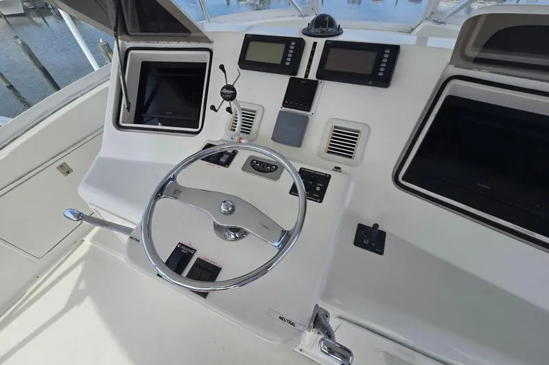 Slide: The Image of Helm of 2004 Ocean Yachts 50 Super Sport with steering wheel and navigation controls. - 35