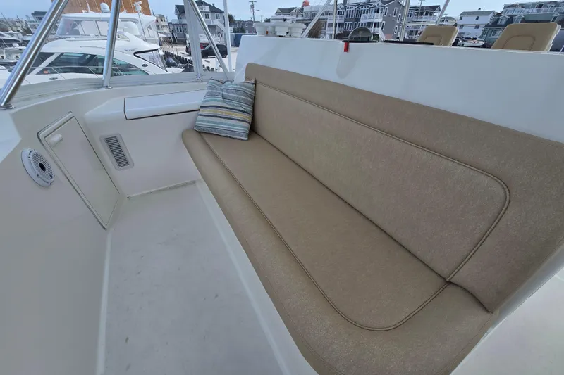 Slide: The Image of 2004 Ocean Yachts 50 Super Sport boat seating area with cushion and striped pillow. - 42