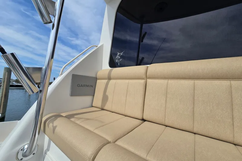 Slide: The Image of 2004 Ocean Yachts 50 Super Sport with beige seating and Garmin equipment, docked under blue sky. - 46