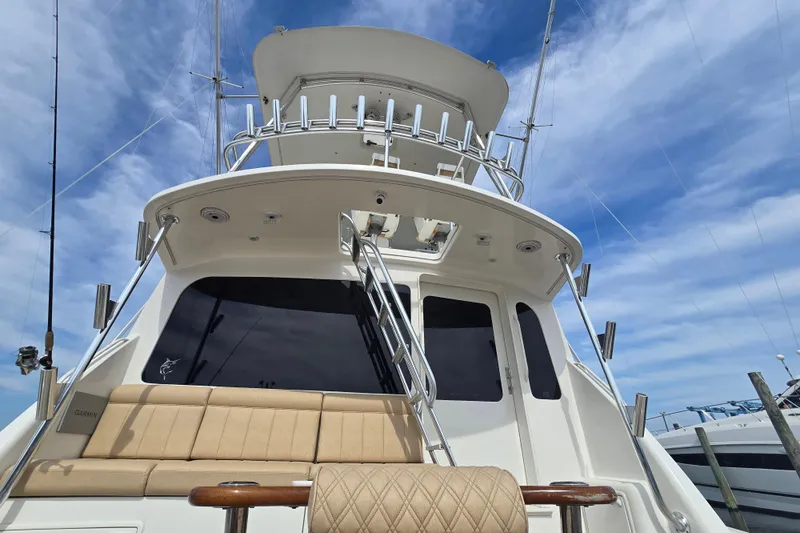 Slide: The Image of 2004 Ocean Yachts 50 Super Sport boat with flybridge, under a clear blue sky. - 47