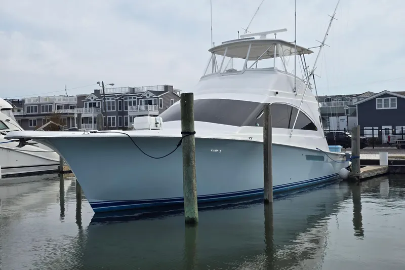 Slide: The Image of 2004 Ocean Yachts 50 Super Sport docked in a marina, with waterfront homes in the background. - 5