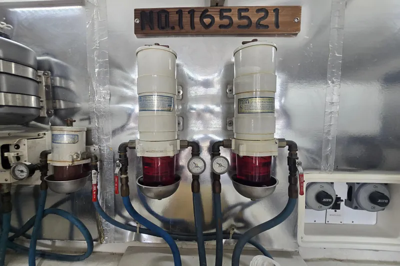 Slide: The Image of Engine room of 2004 Ocean Yachts 50 Super Sport with fuel filters and gauges. - 53