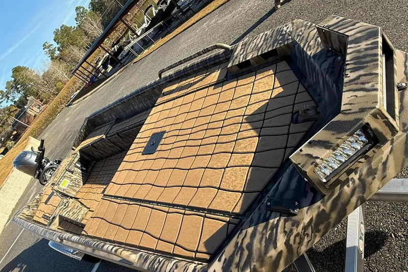 Slide: The Image of 2026 Excel 1751 Shallow Water F4 boat with camouflage design on a trailer. - 4