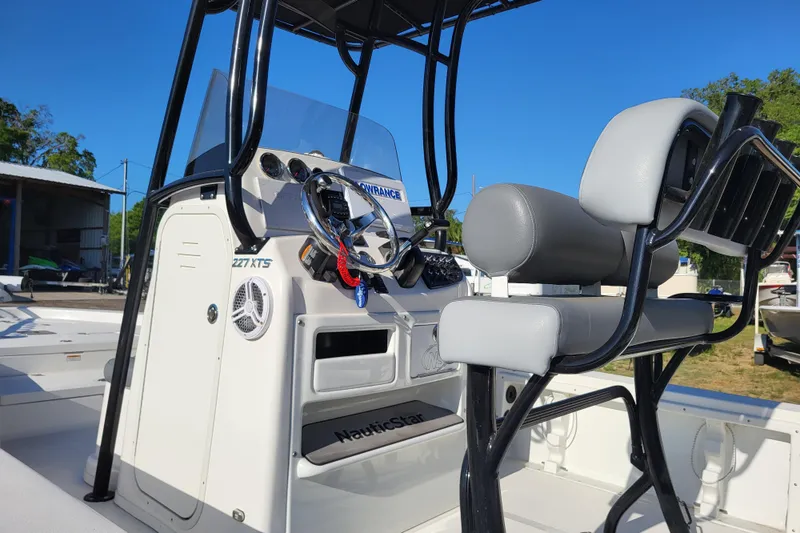 Slide: The Image of 2023 NauticStar 227 XTS boat interior with steering console and seating. - 5