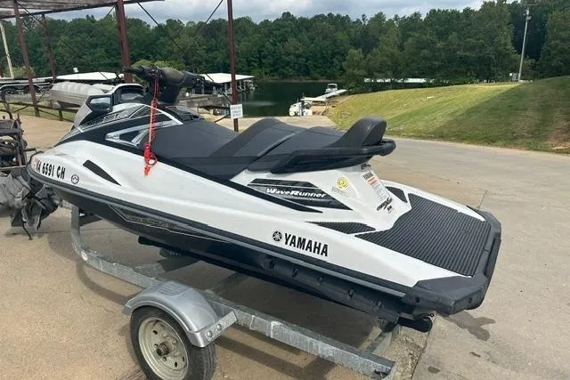 Slide: The Image of 2016 Yamaha WaveRunner VX Cruiser on trailer, parked near a lake with lush greenery. - 5