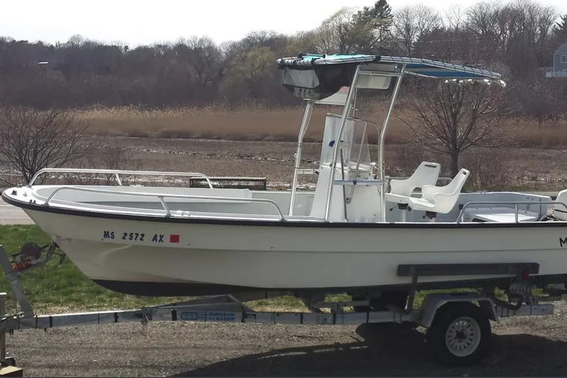 The Image of 1993 Maritime Skiff 2090cc boat on trailer, parked outdoors near trees and grass. - 0
