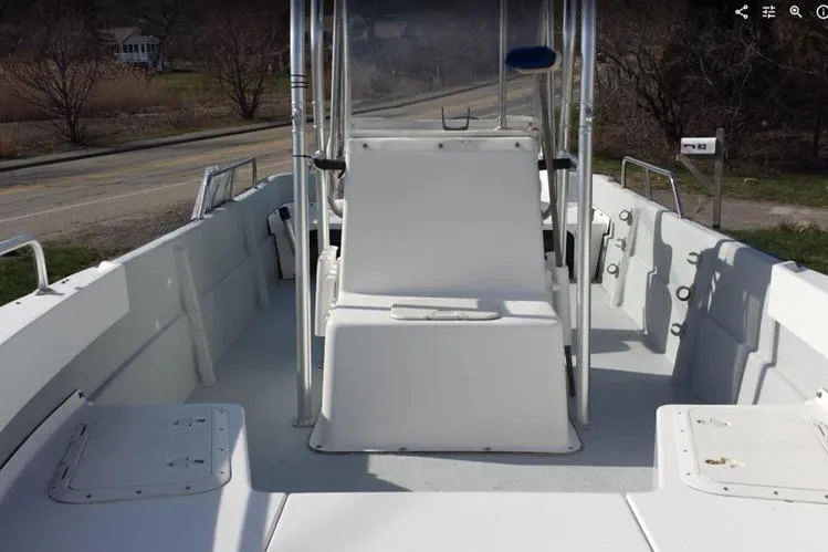 Slide: The Image of 1993 Maritime Skiff 2090cc boat interior with center console and seating. - 1