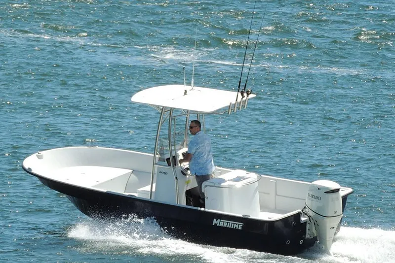 Slide: The Image of A 1993 Maritime Skiff 2090cc boat cruising on open water with a Suzuki outboard motor. - 6