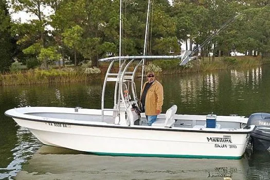 Slide: The Image of 1993 Maritime Skiff 2090cc boat on calm water with a person onboard. - 7