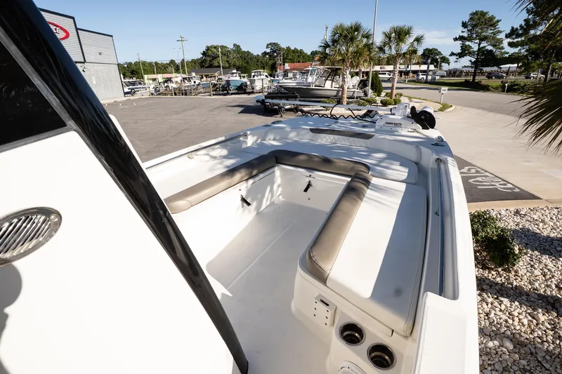 Slide: The Image of 2023 World Cat 235 CC boat with spacious seating, docked in a sunny marina. - 11