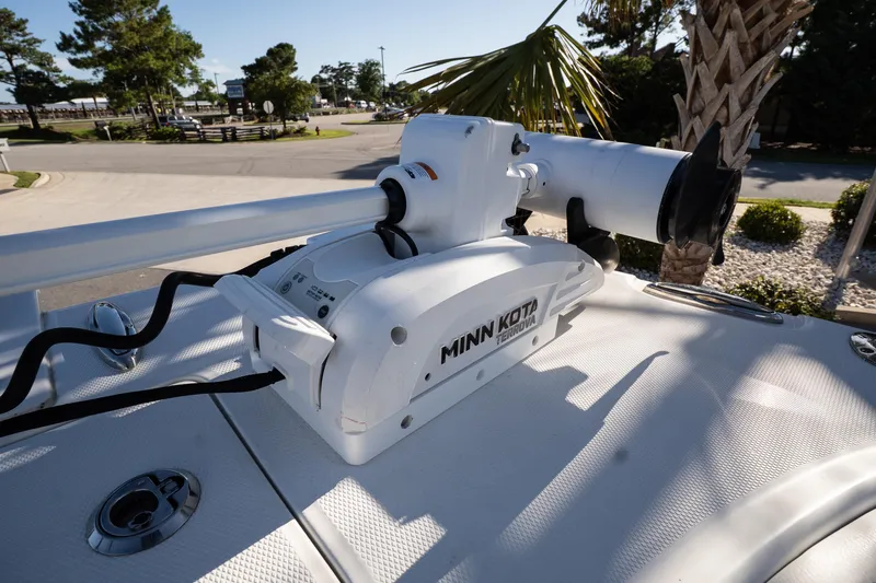 Slide: The Image of Minn Kota Terrova motor on 2023 World Cat 235 CC boat, parked near palm trees. - 12