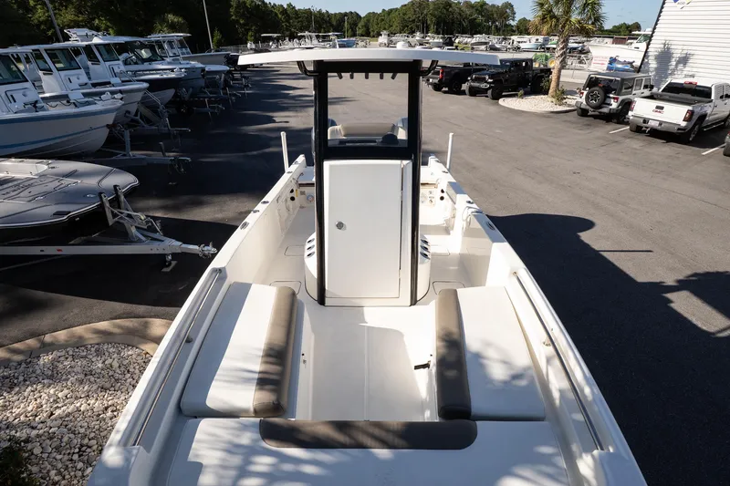 Slide: The Image of 2023 World Cat 235 CC boat in a dealership lot, showcasing seating and console. - 13