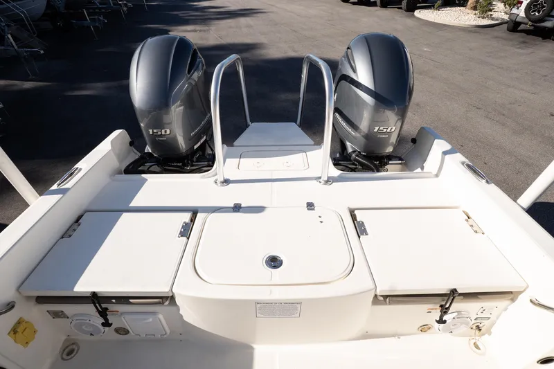Slide: The Image of 2023 World Cat 235 CC boat with dual 150 horsepower engines, rear deck view. - 17