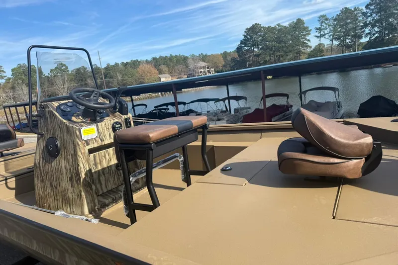 Slide: The Image of 2026 Excel 206 Stalker CC boat with seating, steering console, and lake view. - 3