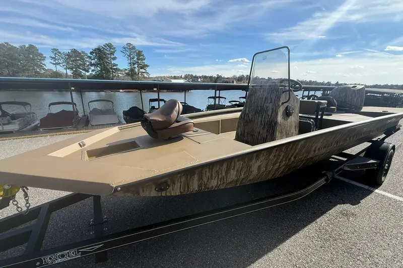 Slide: The Image of 2026 Excel 206 Stalker CC boat on trailer by a lakeside dock. - 6