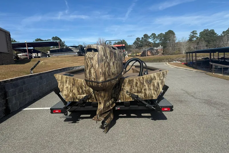 Slide: The Image of 2026 Excel 206 Stalker CC boat with camouflage design on a trailer in a parking area. - 8