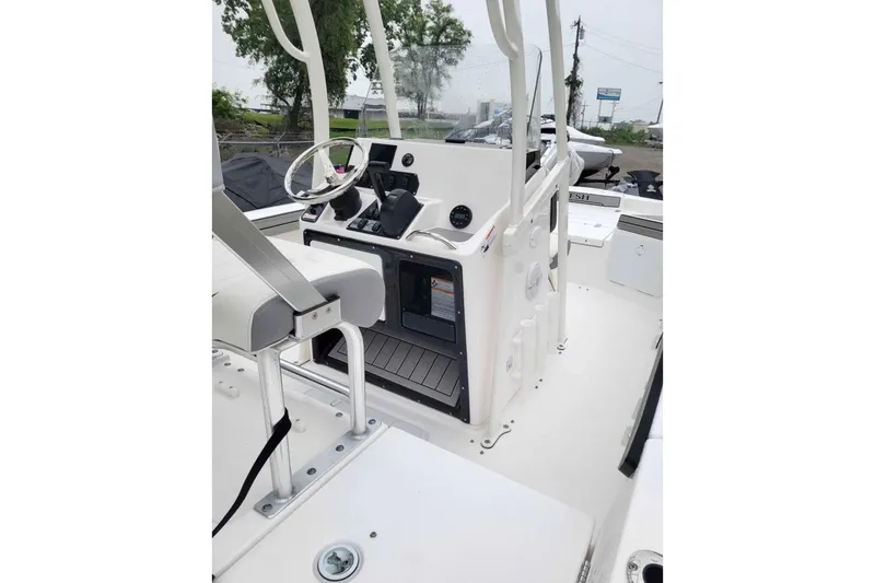 Slide: The Image of 2024 Yamaha Boats 190 FSH Sport interior, featuring helm and seating area. - 4