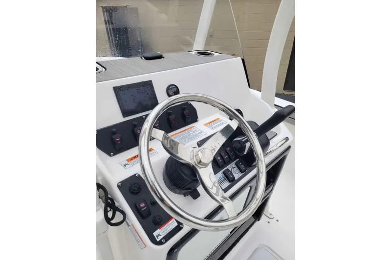 Slide: The Image of 2024 Yamaha Boats 190 FSH Sport dashboard with steering wheel and controls. - 5