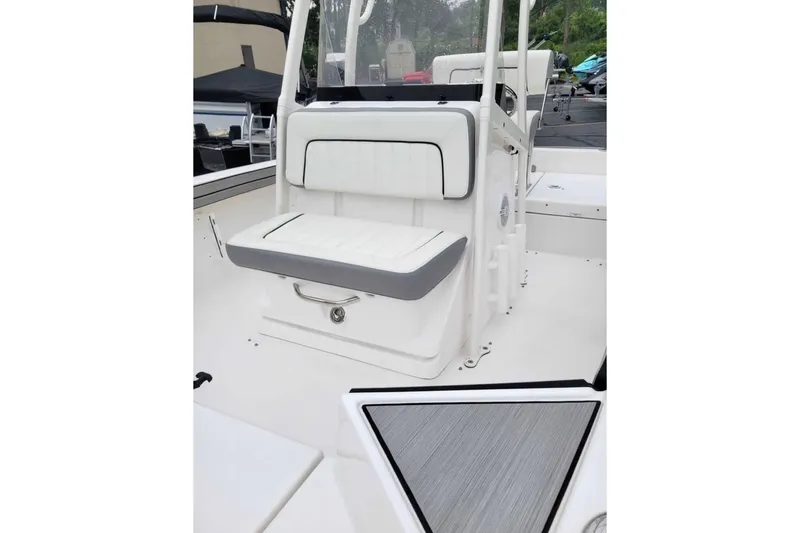 Slide: The Image of 2024 Yamaha Boats 190 FSH Sport interior with white seating and console. - 6