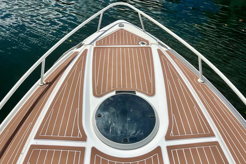 Slide: The Image of Bow of 2011 Deep Impact 36 Open boat with teak decking on water. - 10
