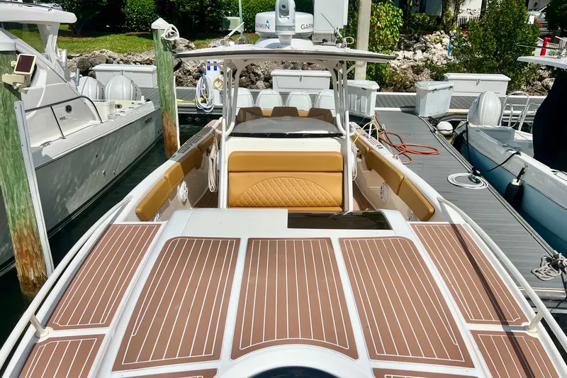 Slide: The Image of 2011 Deep Impact 36 Open boat docked, featuring sleek design and spacious deck. - 12