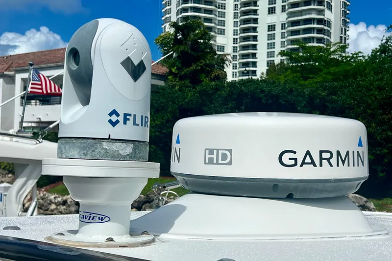 Slide: The Image of FLIR and Garmin equipment on 2011 Deep Impact 36 Open boat, with buildings in background. - 16