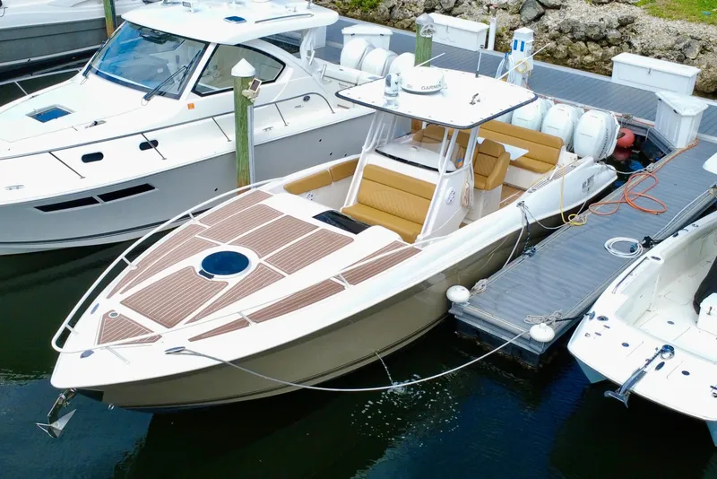 Slide: The Image of 2011 Deep Impact 36 Open boat docked, featuring sleek design and spacious seating. - 2