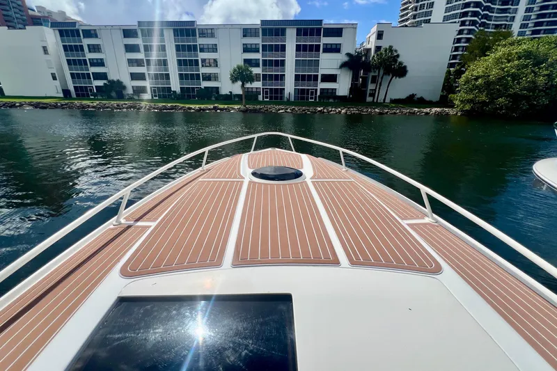 Slide: The Image of Bow view of 2011 Deep Impact 36 Open boat on calm water near buildings. - 20