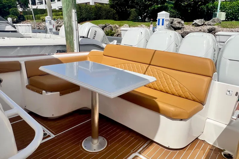 Slide: The Image of Luxurious seating area on 2011 Deep Impact 36 Open boat with tan upholstery and table. - 22