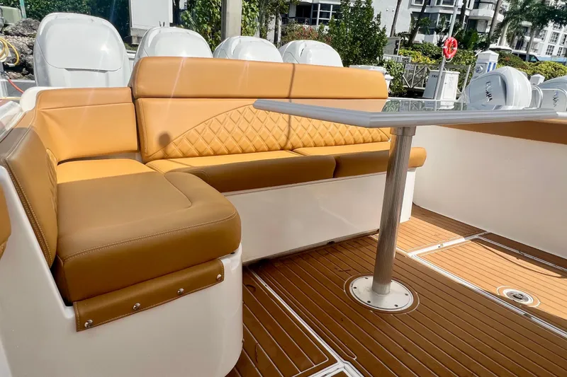 Slide: The Image of Luxurious seating area on 2011 Deep Impact 36 Open boat with tan upholstery and table. - 24