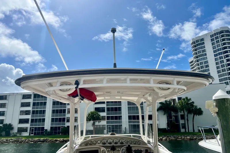 Slide: The Image of 2011 Deep Impact 36 Open boat with T-top, docked near waterfront buildings. - 25