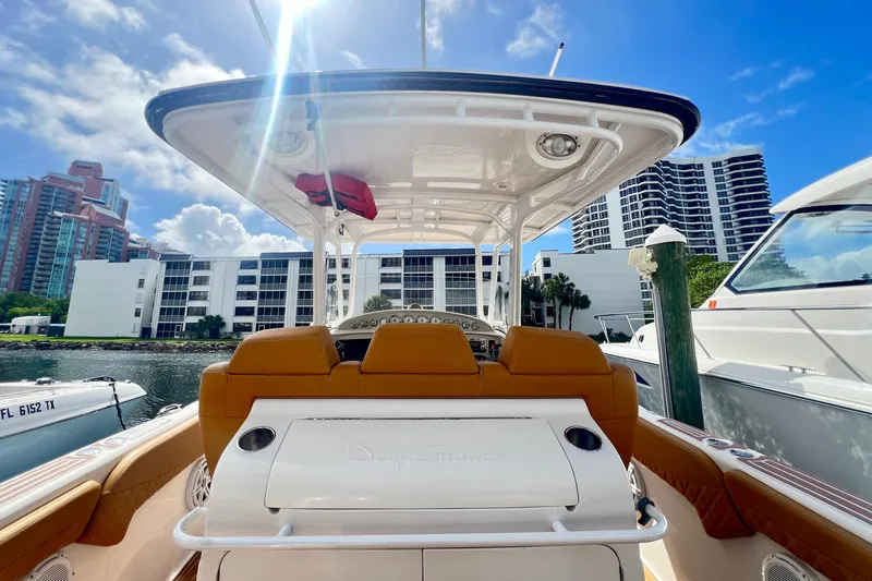 Slide: The Image of 2011 Deep Impact 36 Open boat docked, with cityscape and blue sky background. - 26