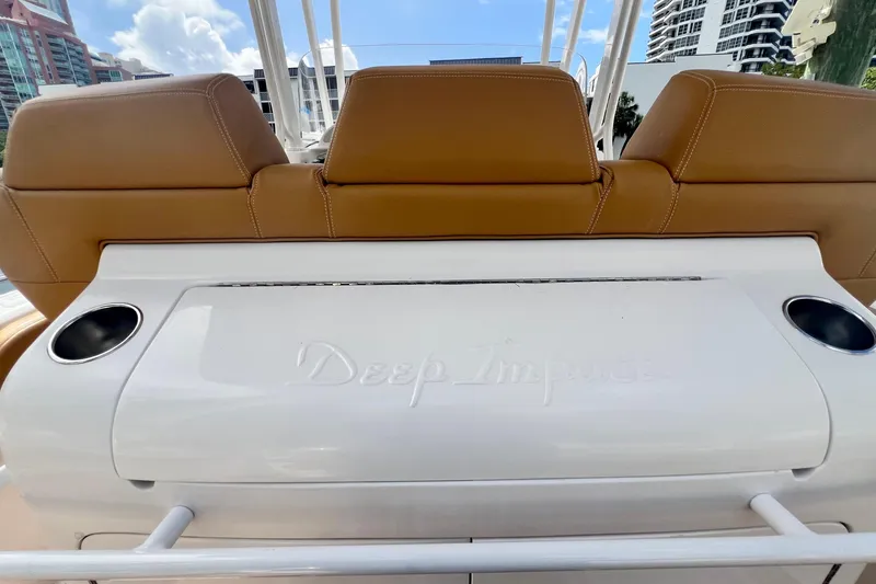 Slide: The Image of 2011 Deep Impact 36 Open boat interior with tan seats and cup holders. - 27