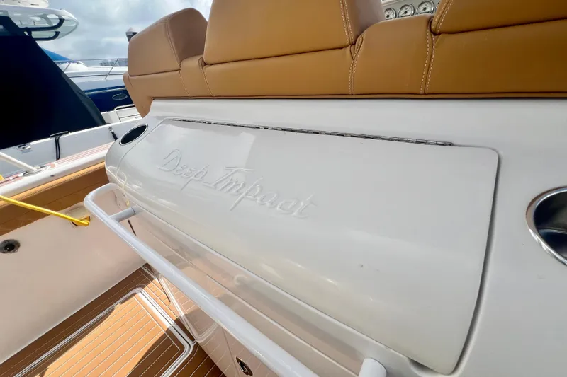 Slide: The Image of 2011 Deep Impact 36 Open boat interior with tan seating and branded compartment. - 29