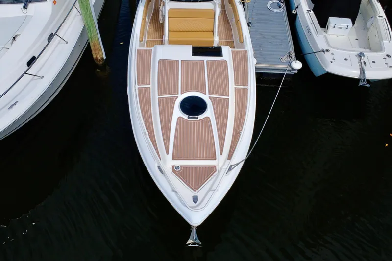 Slide: The Image of Overhead view of 2011 Deep Impact 36 Open boat docked, featuring sleek design and wood accents. - 3